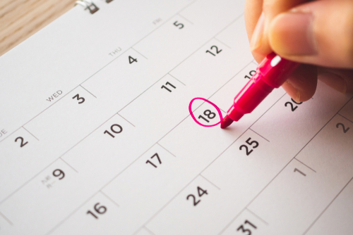 Female hand on the calendar date